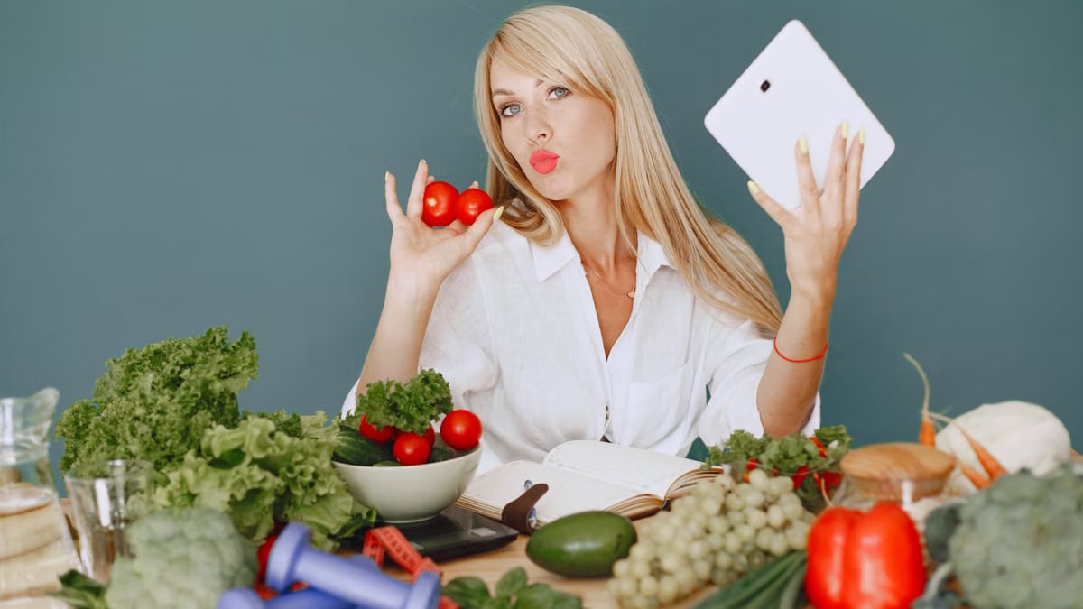 Vlogger promoting healthy eating with fresh vegetables on the table.